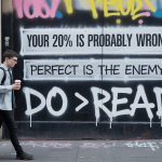 Graffiti with the phrase “Your 20% is probably wrong. Perfect is the enemy. Do > Read”, illustrating the 80/20 rule for learning and avoiding perfectionism.